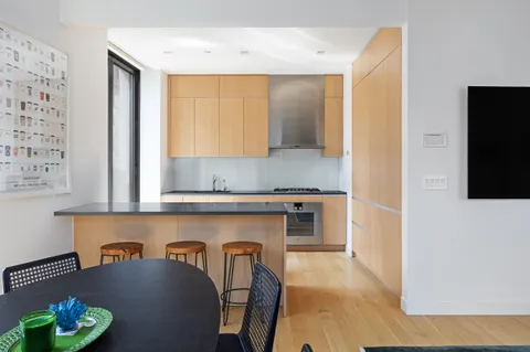 a kitchen with stainless steel appliances granite countertop a refrigerator and a stove top oven