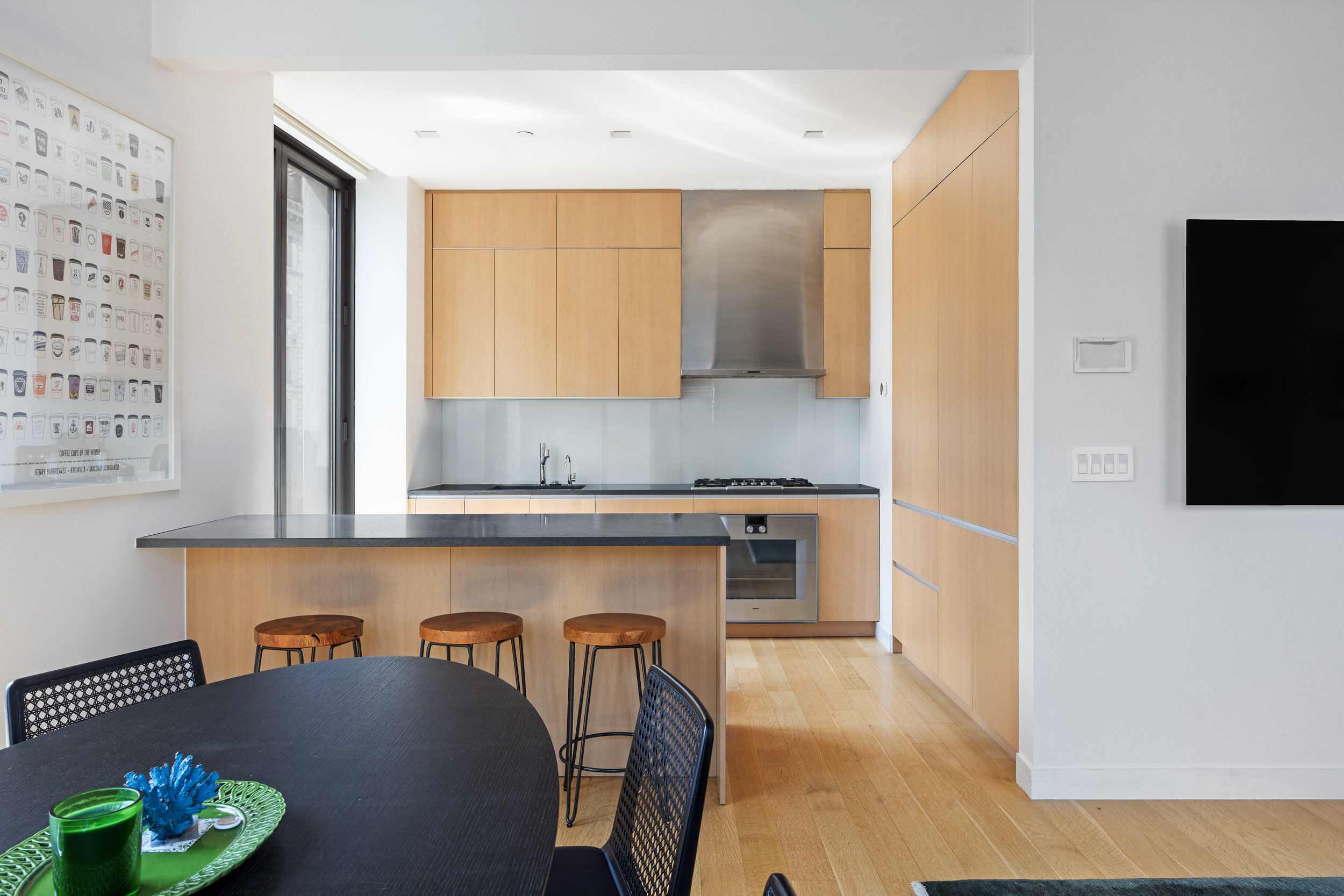 21 East 12th Street, Unit 8A Manhattan, NY 10003 - Photo 6 of 20 a kitchen with stainless steel appliances granite countertop a refrigerator and a stove top oven
