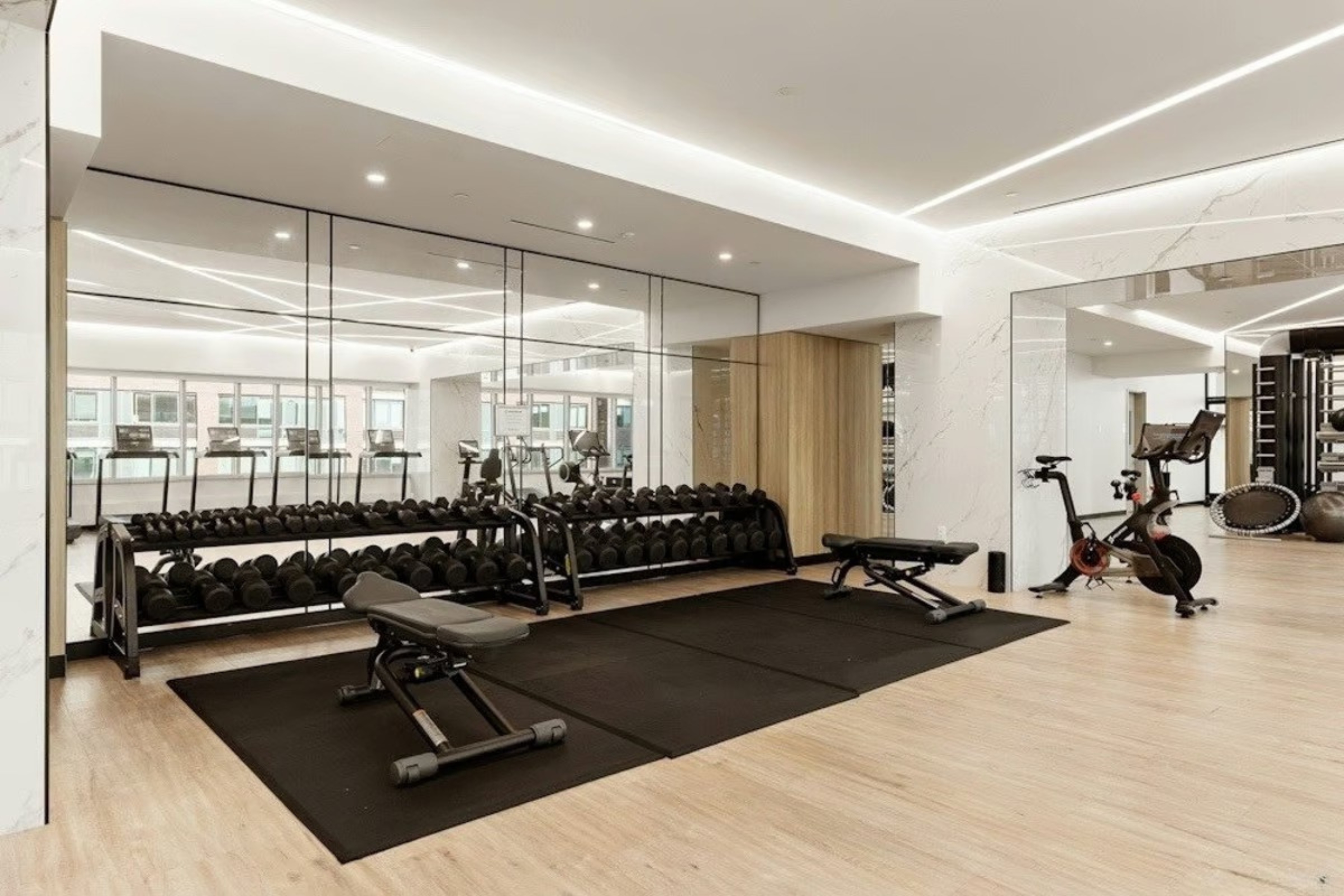 46-30 Center Boulevard, Unit 610 Queens, NY 11109 - Photo 13 of 19 a room with gym equipment and view of living room