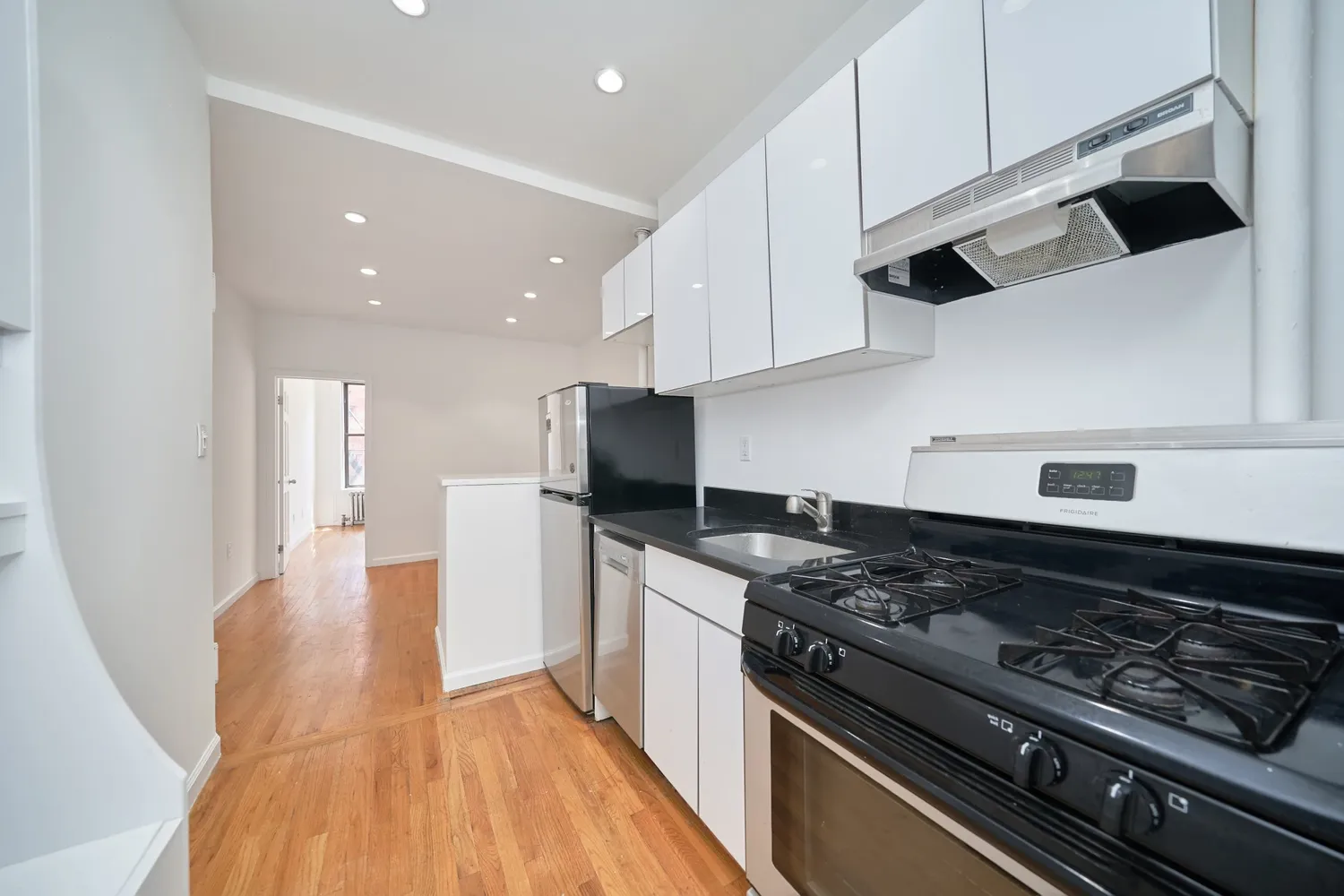 a kitchen with stainless steel appliances granite countertop a stove and a refrigerator