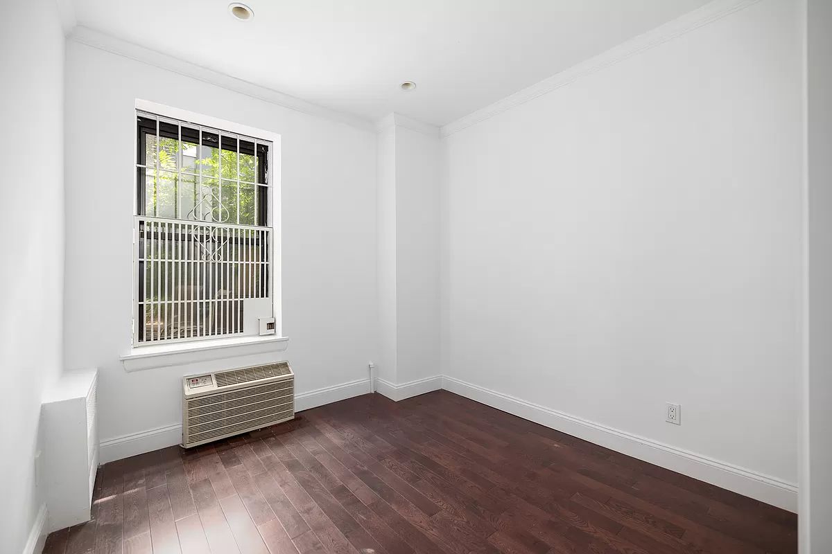 328 West 19th Street, Unit 1B Manhattan, NY 10011 - Photo 5 of 11 a view of a room with wooden floors and cabinet