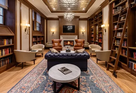 a living room with furniture and a bookshelf