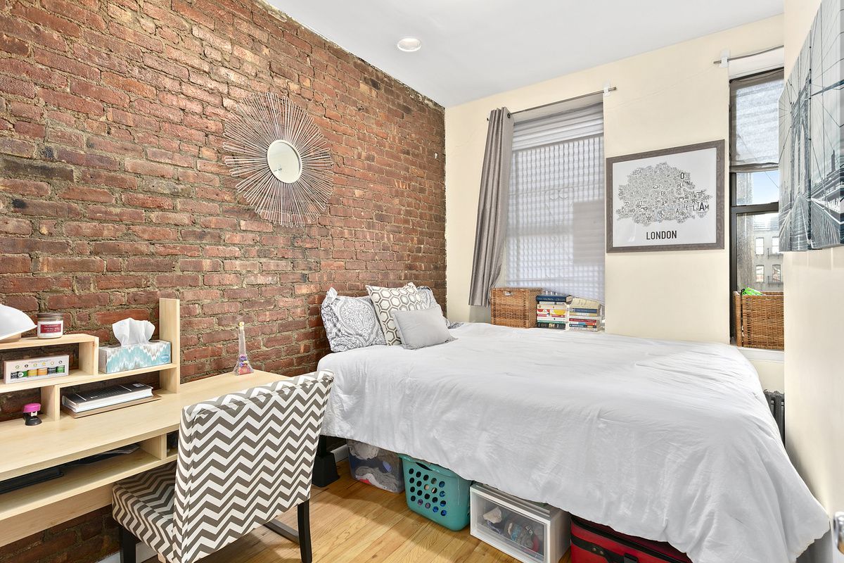 309 East 95th Street, Unit 27 Manhattan, NY 10128 - Photo 5 of 8 a bedroom with a bed and a wall painting