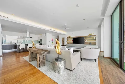 a living room with furniture wooden floor and a flat screen tv