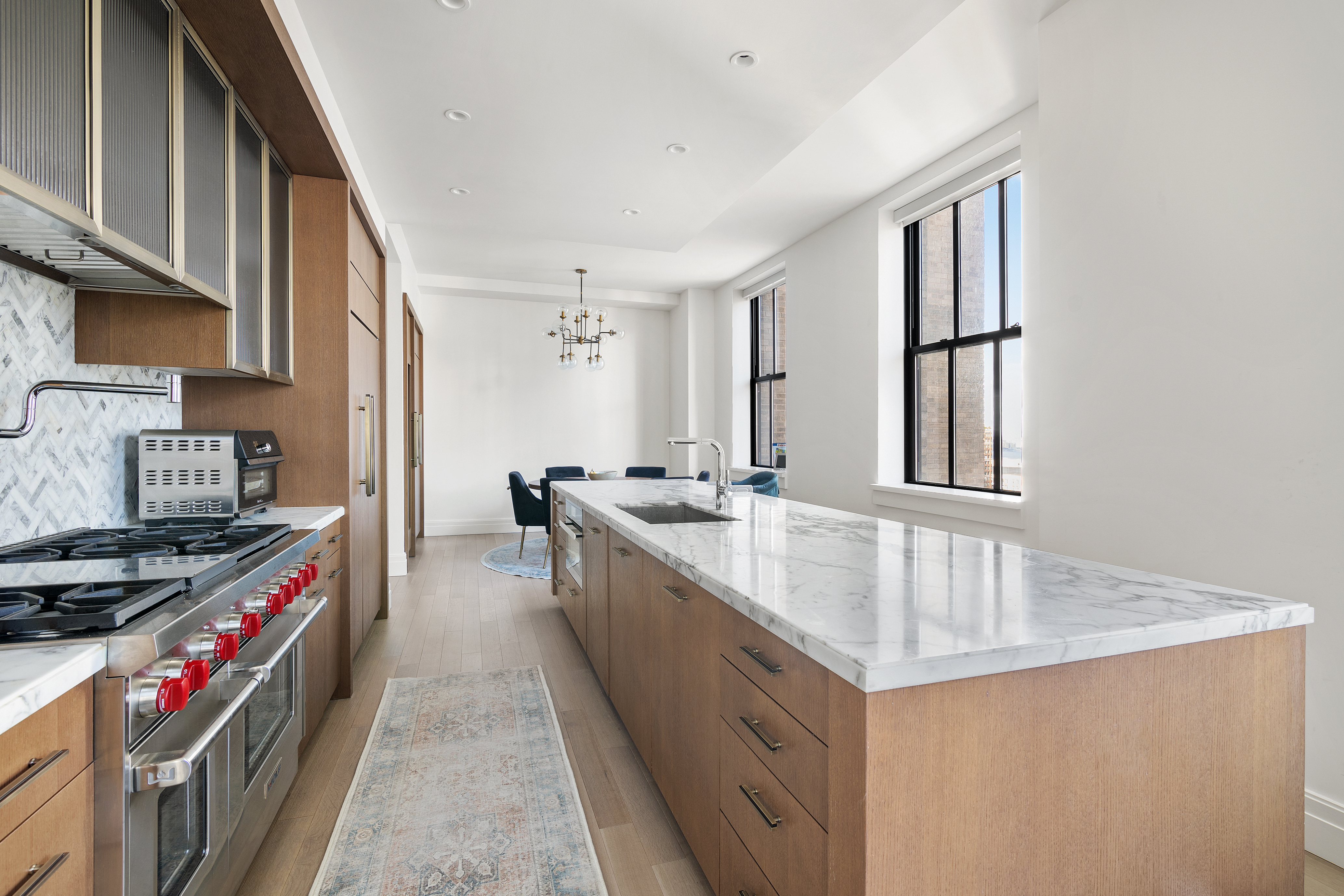 100 Barclay Street, Unit 16D Manhattan, NY 10007 - Photo 3 of 14 a large kitchen with stainless steel appliances granite countertop a sink stove and cabinets