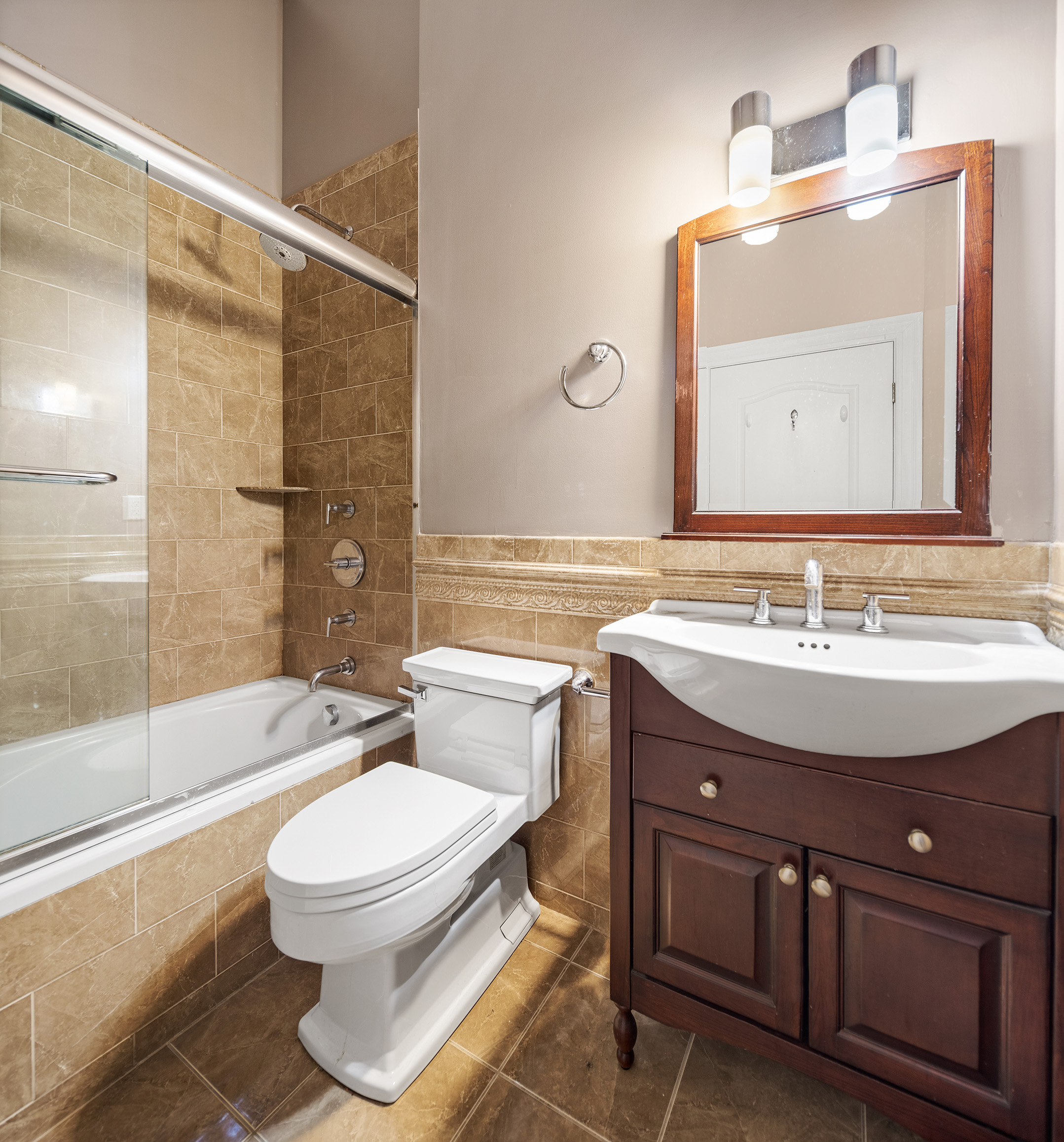 733 9th Avenue, Unit 5 Manhattan, NY 10019 - Photo 8 of 9 a bathroom with a sink toilet and shower