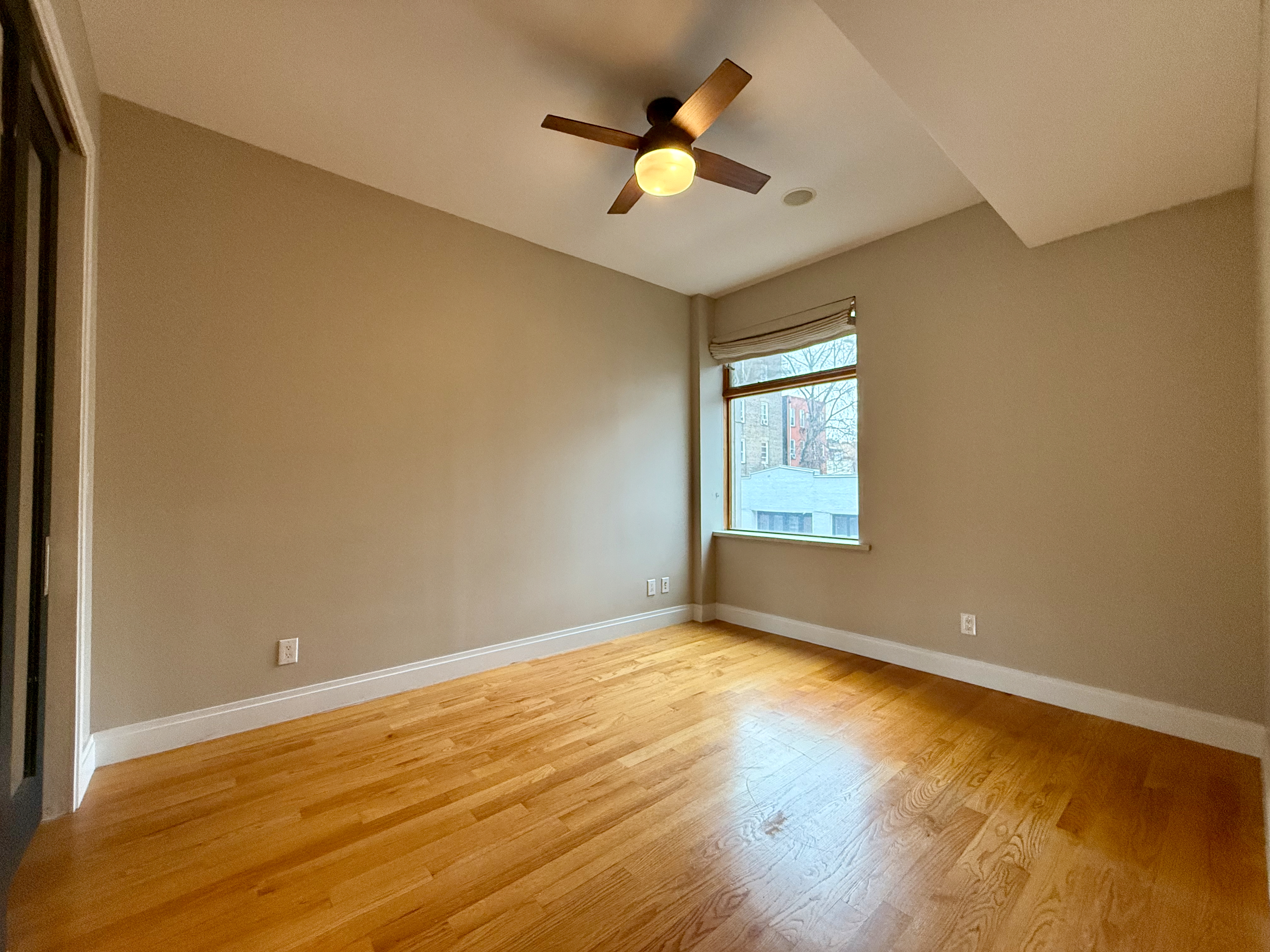 151 Green Street, Unit 2A Brooklyn, NY 11222 - Photo 4 of 6 an empty room with a window and a ceiling fan