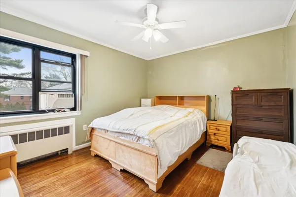 a large bed sitting in a bedroom next to a cabinet