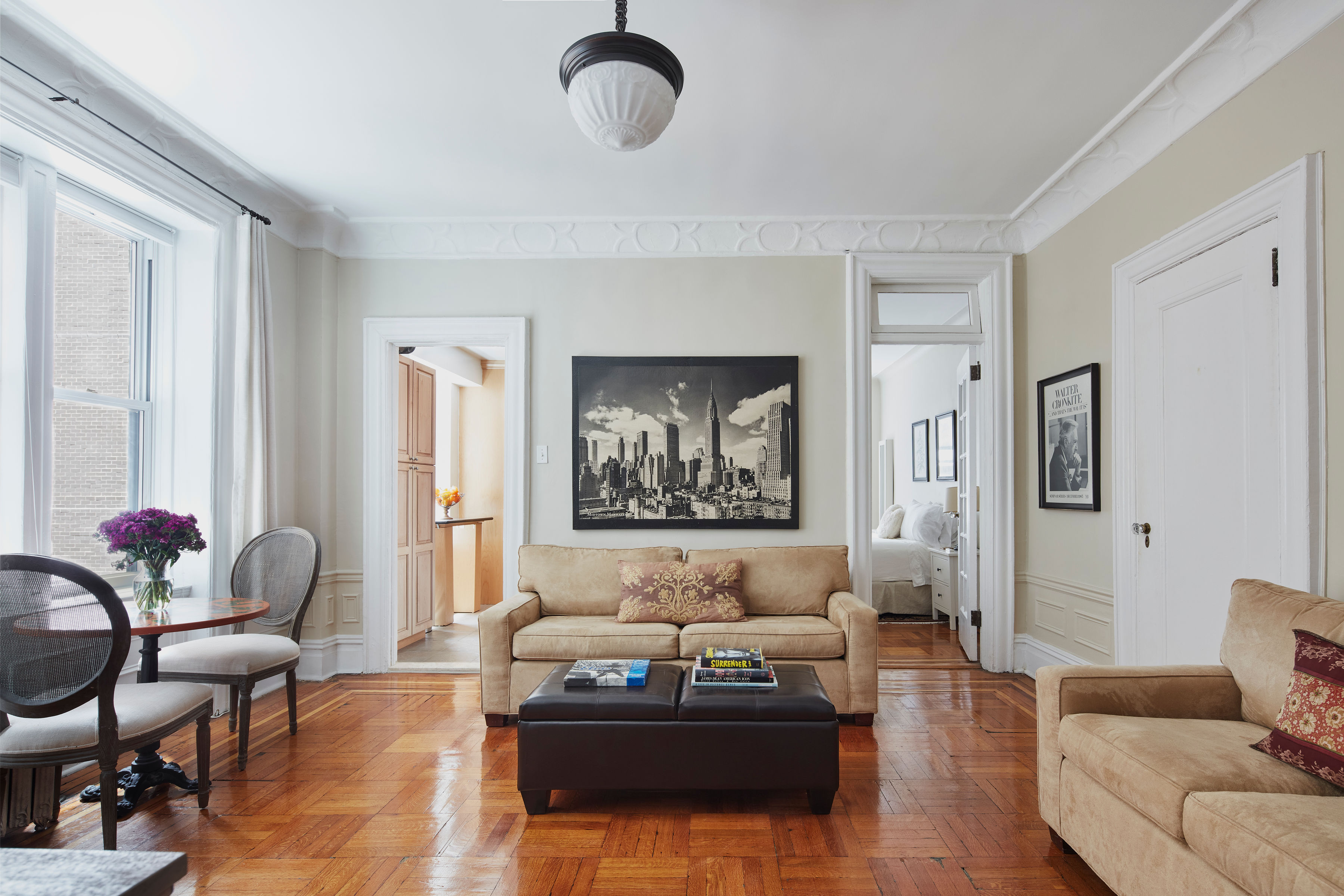 200 West 54th Street, Unit 4H Manhattan, NY 10019 - Photo 1 of 8 a living room with furniture and wooden floor