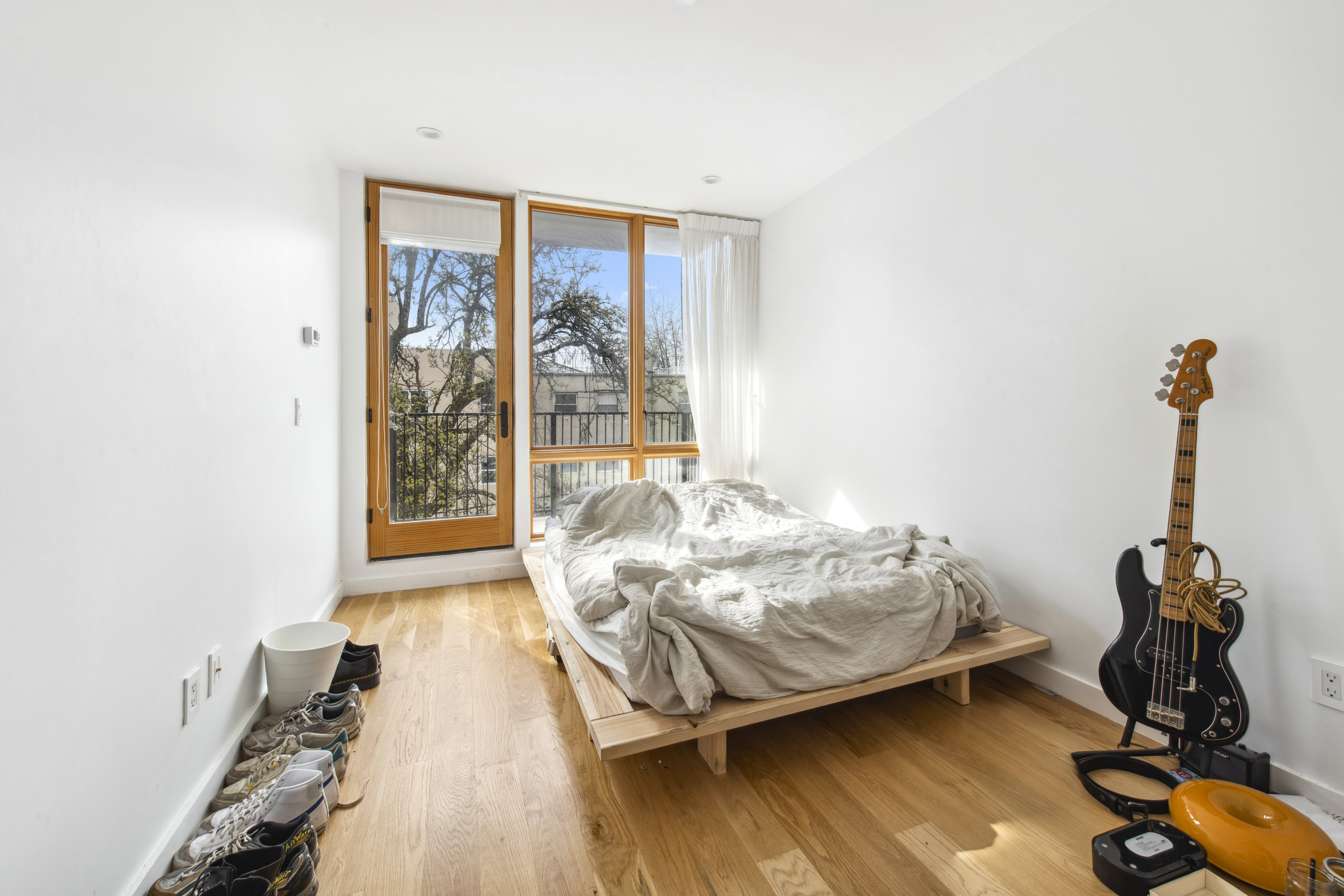 42 Rochester Avenue, Unit 3 Brooklyn, NY 11233 - Photo 8 of 18 a bed sitting in a room next to a window