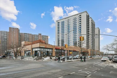 a large building with a street sign on a road