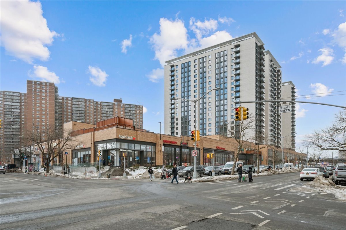 448 Neptune Avenue, Unit 16K Brooklyn, NY 11224 - Photo 22 of 28 a large building with a street sign on a road