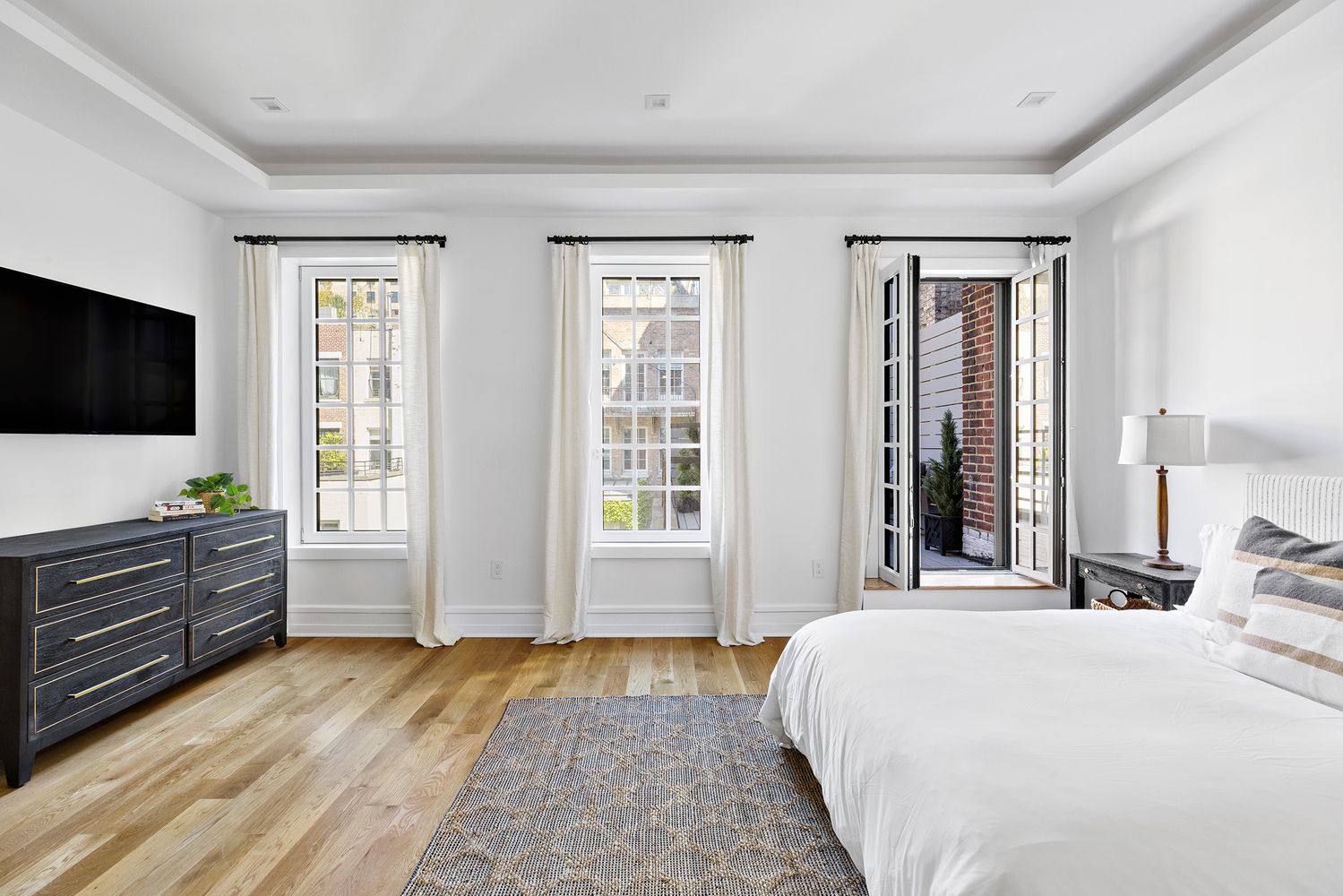 a bedroom with a bed and a flat screen tv