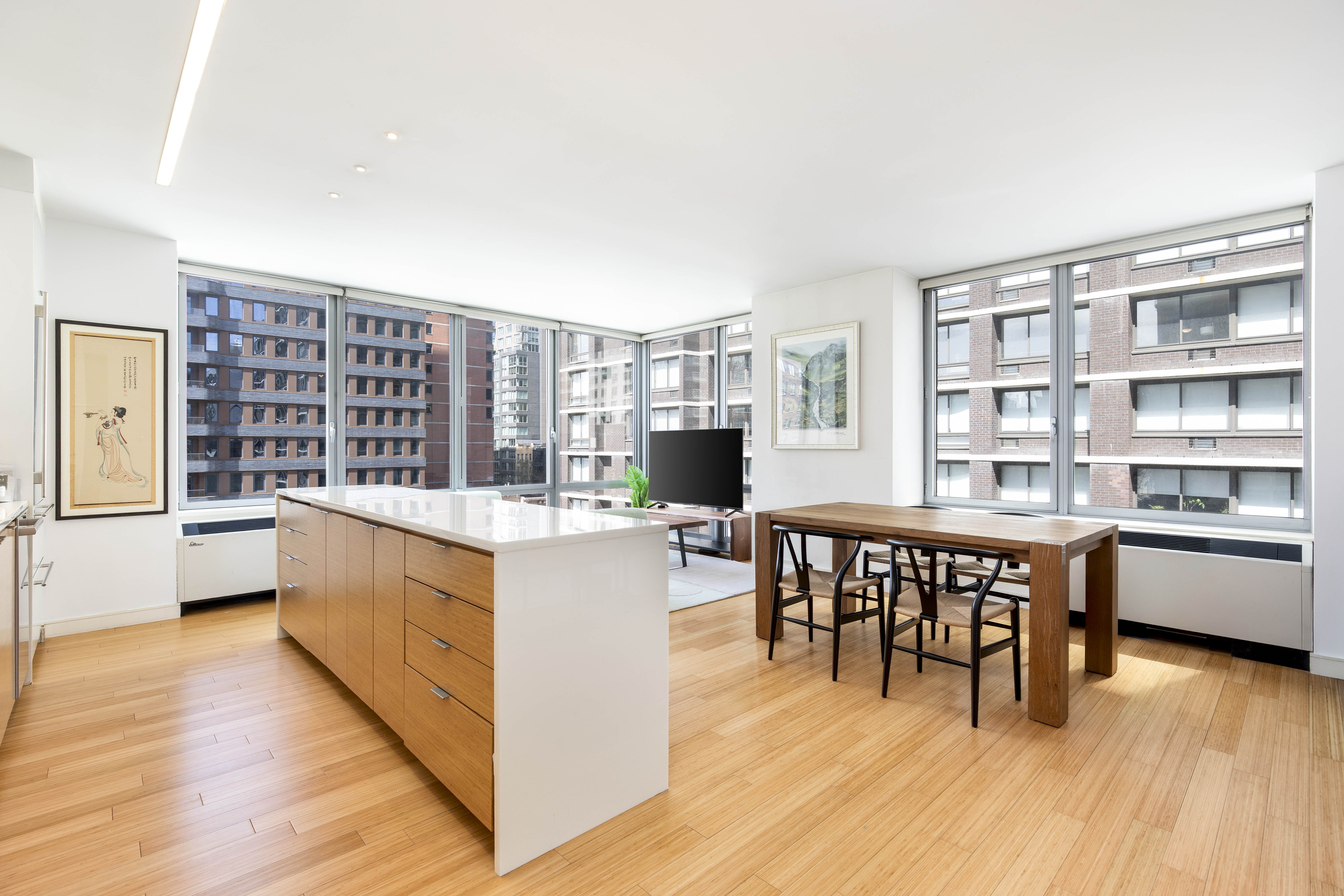 303 East 33rd Street, Unit 7N Manhattan, NY 10016 - Photo 1 of 15 a kitchen with stainless steel appliances granite countertop a table chairs stove and a wooden floors
