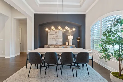 a dining room with furniture and window