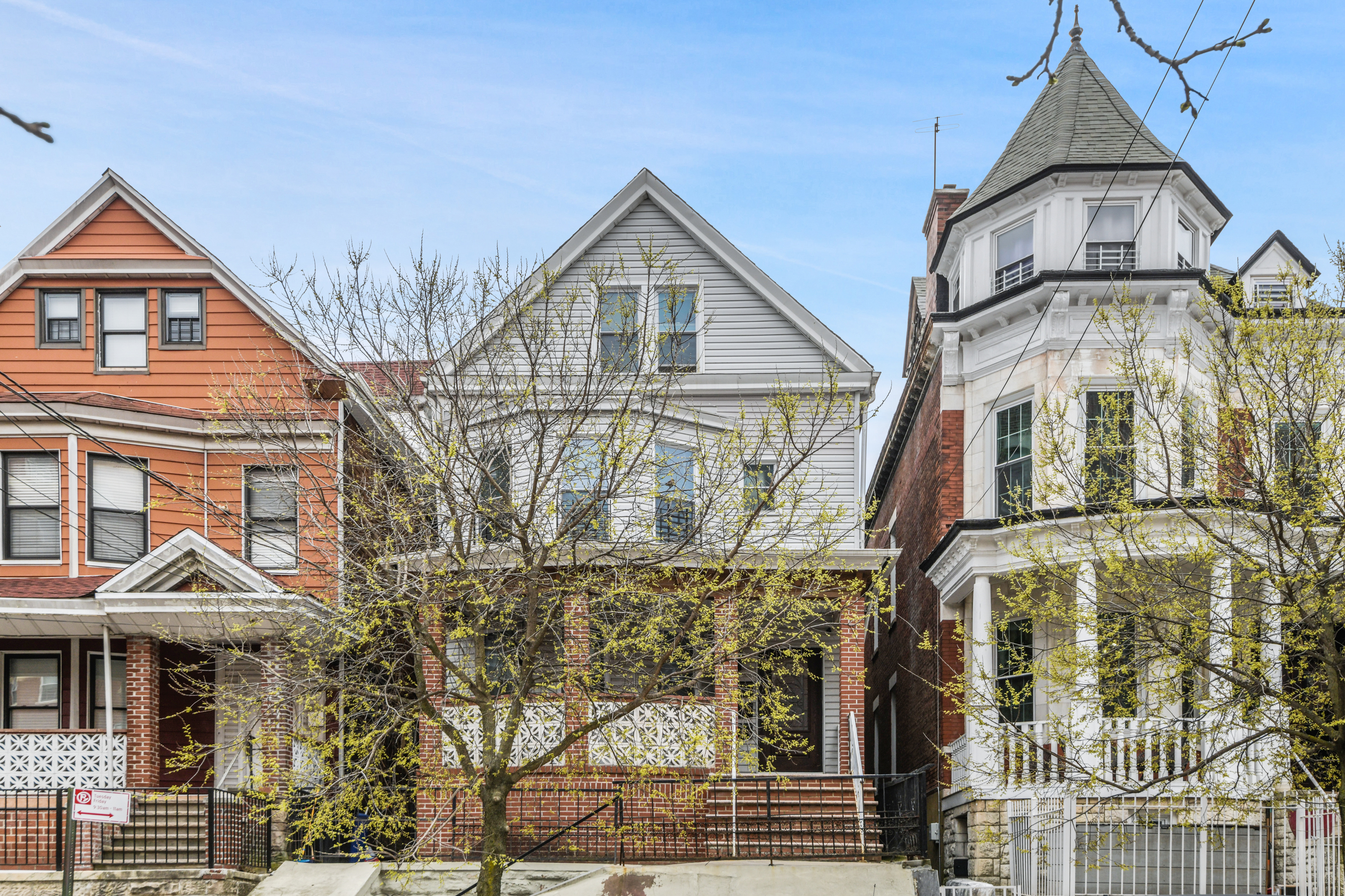 332 East 198th Street, Unit 2 Bronx, NY 10458 - Photo 10 of 10 a front view of a residential apartment building with a yard
