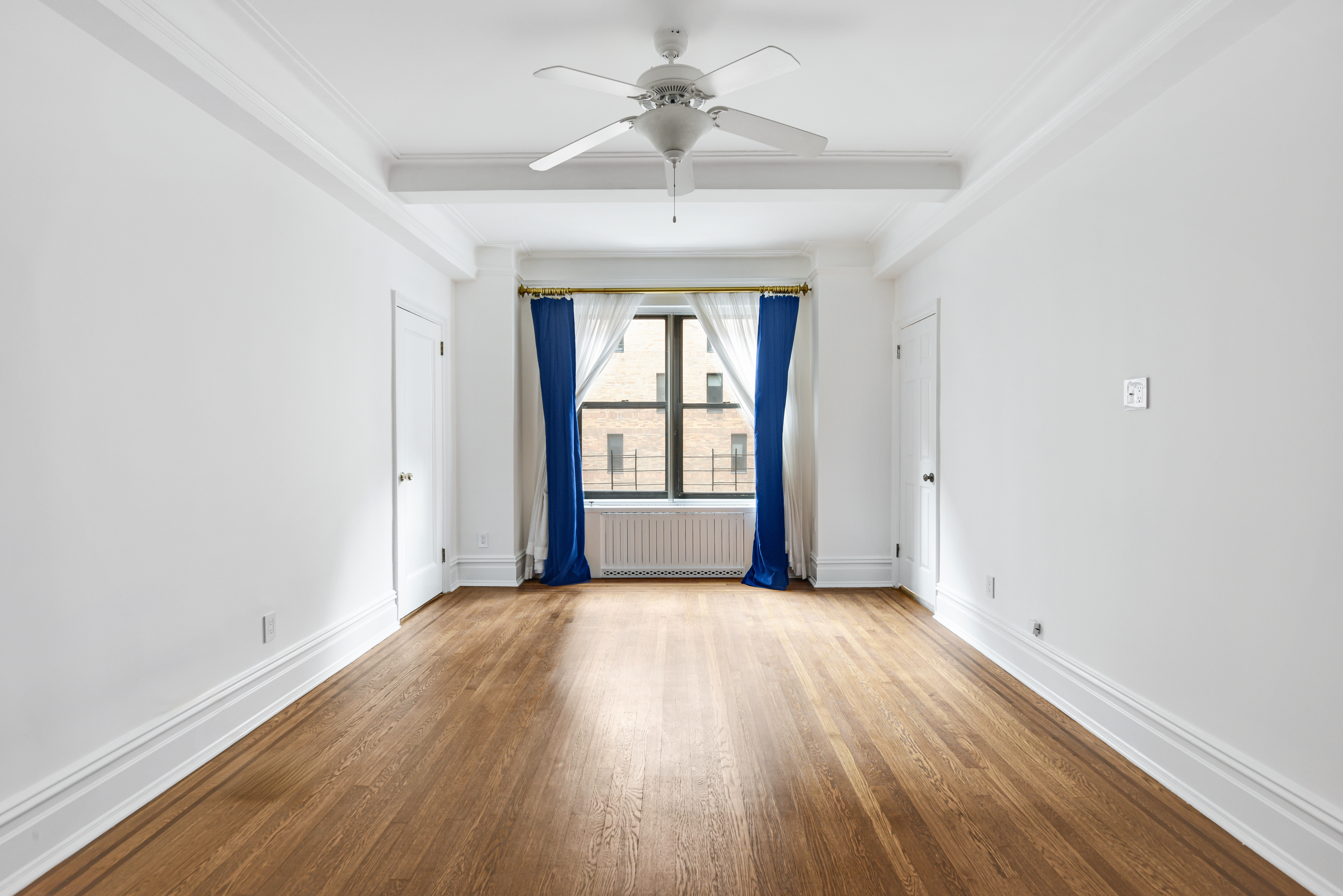 7 Park Avenue, Unit 8A9ABC Manhattan, NY 10016 - Photo 14 of 23 an empty room with wooden floor chandelier and windows