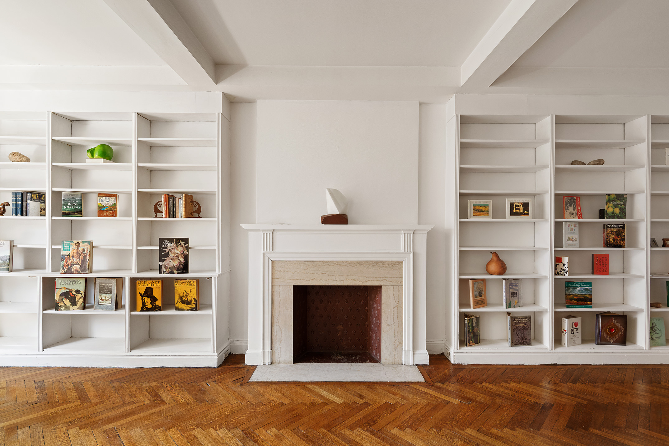 45 Gramercy Park North, Unit 4B Manhattan, NY 10010 - Photo 4 of 13 a living room with a bookshelf and a fireplace