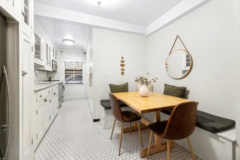 a kitchen with granite countertop a sink and cabinets
