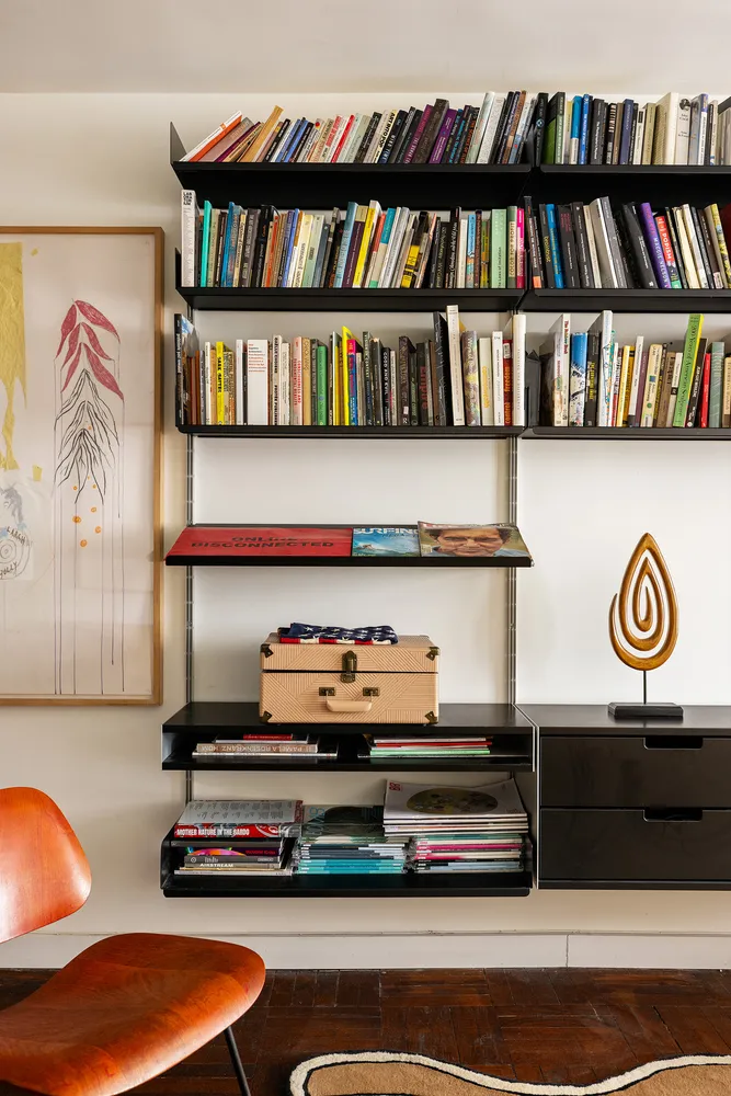 a living room with furniture cabinets and book shelf