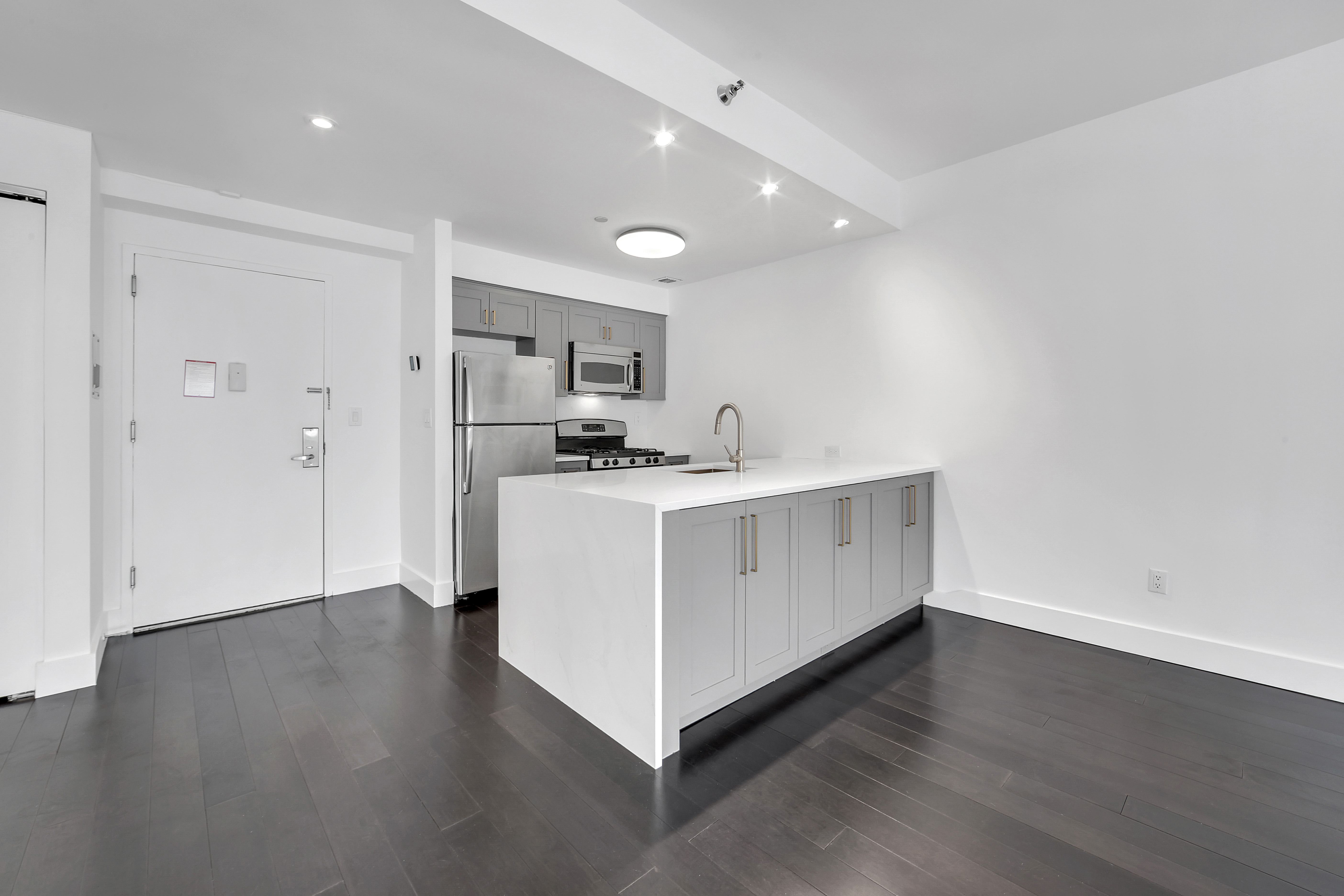 516 West 47th Street, Unit S1B Manhattan, NY 10036 - Photo 5 of 17 a view of kitchen with cabinets and wooden floor
