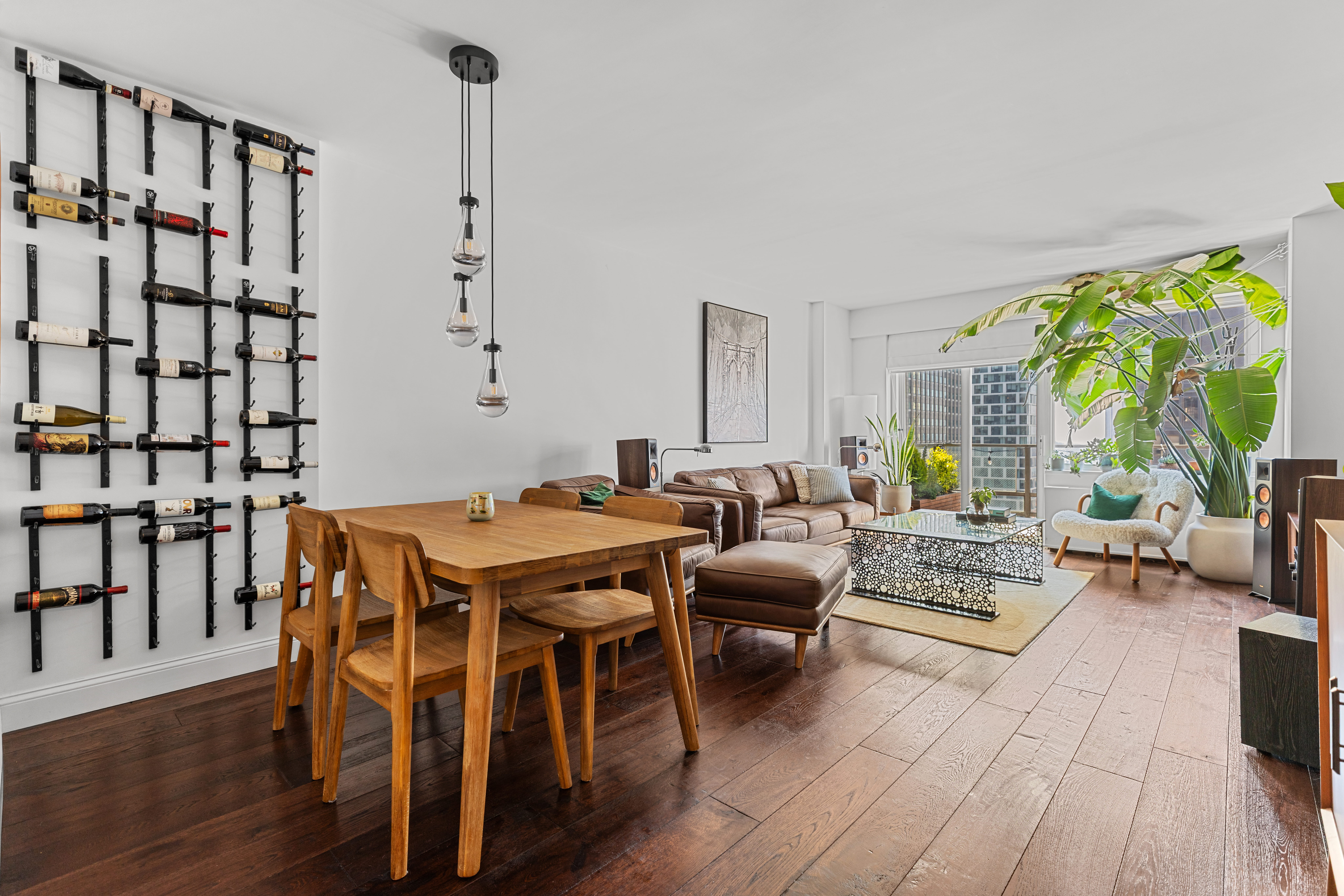 a living room with furniture a rug and a floor to ceiling window