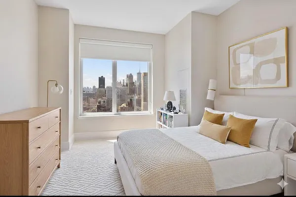 a bedroom with a large bed and a large window