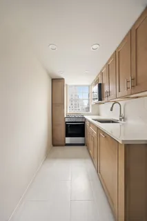 a large kitchen with a sink and cabinets