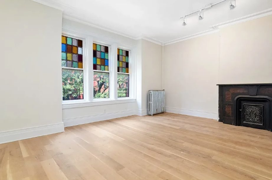 278 Macon Street, Unit 1 Brooklyn, NY 11216 - Photo 3 of 7 a view of an empty room with a window and fire place