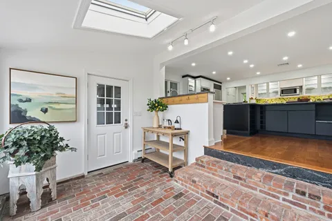 a kitchen with stainless steel appliances kitchen island granite countertop a sink and cabinets