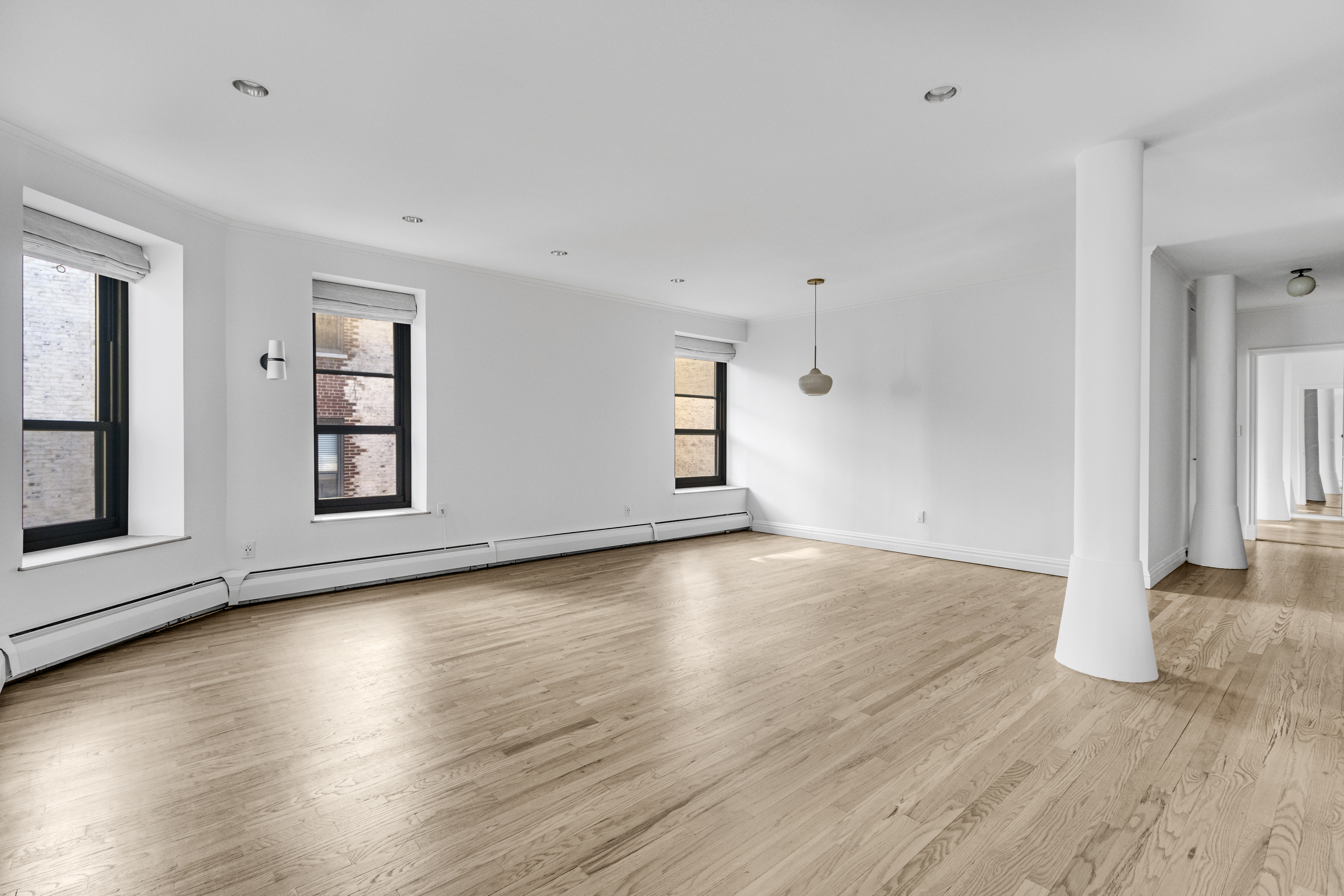 305 West 98th Street, Unit 7CS Manhattan, NY 10025 - Photo 2 of 18 an empty room with wooden floor and windows