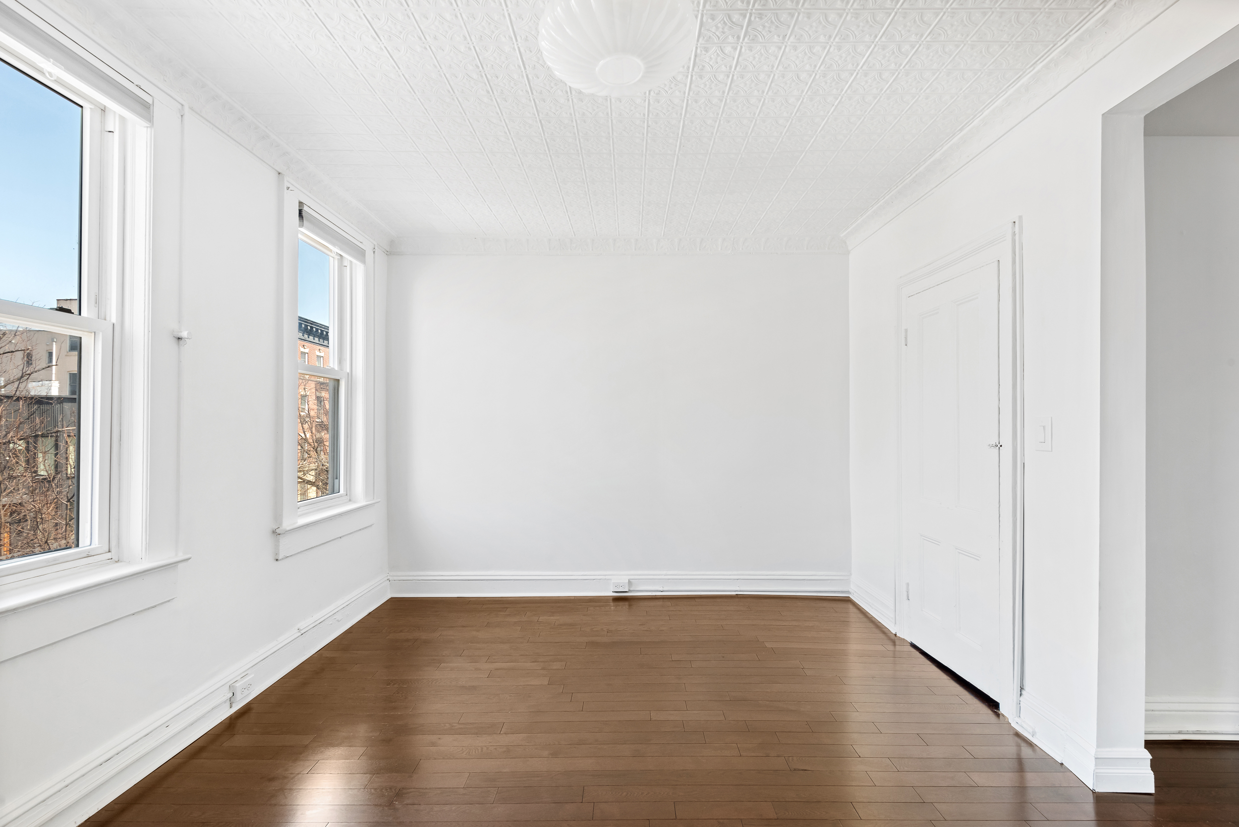 404 A 17th Street, Unit 3 Brooklyn, NY 11215 - Photo 7 of 9 a view of an empty room with wooden floor and a window