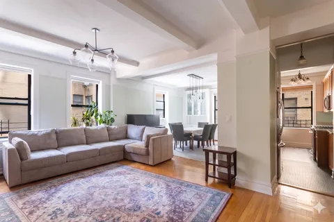 a living room with furniture wooden floor and a chandelier