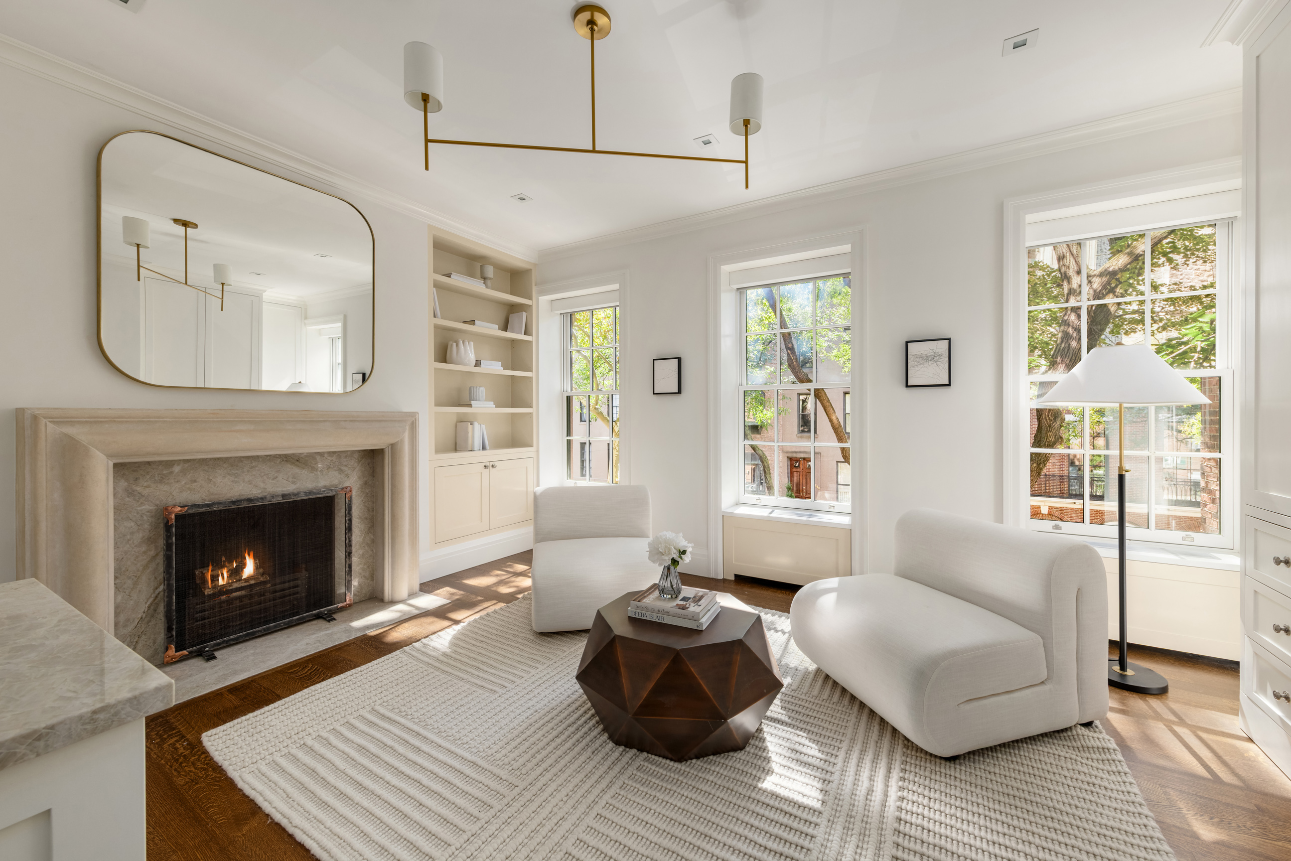 157 East 65th Street Manhattan, NY 10065 - Photo 15 of 28 a living room with furniture and a fireplace
