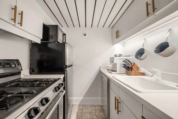 a kitchen with a stove and a sink