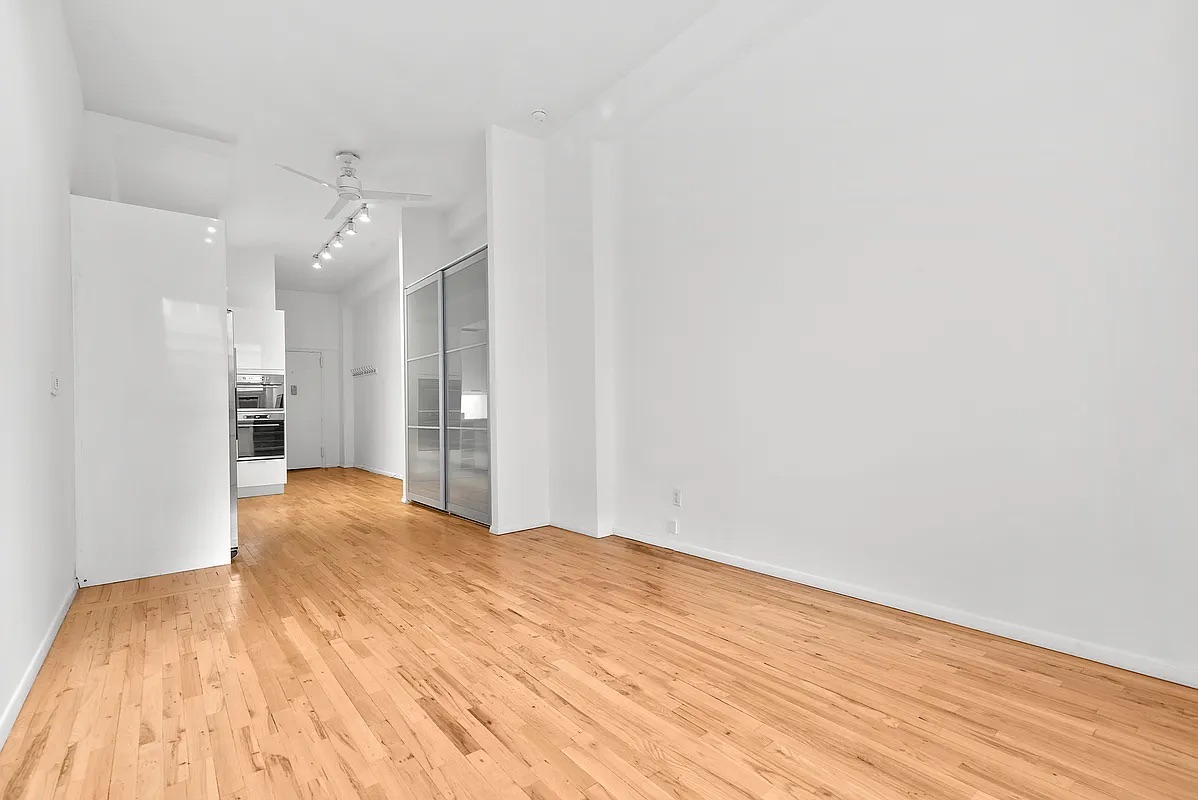 23 Waverly Place, Unit 6M Manhattan, NY 10003 - Photo 8 of 22 a view of an empty room with wooden floor