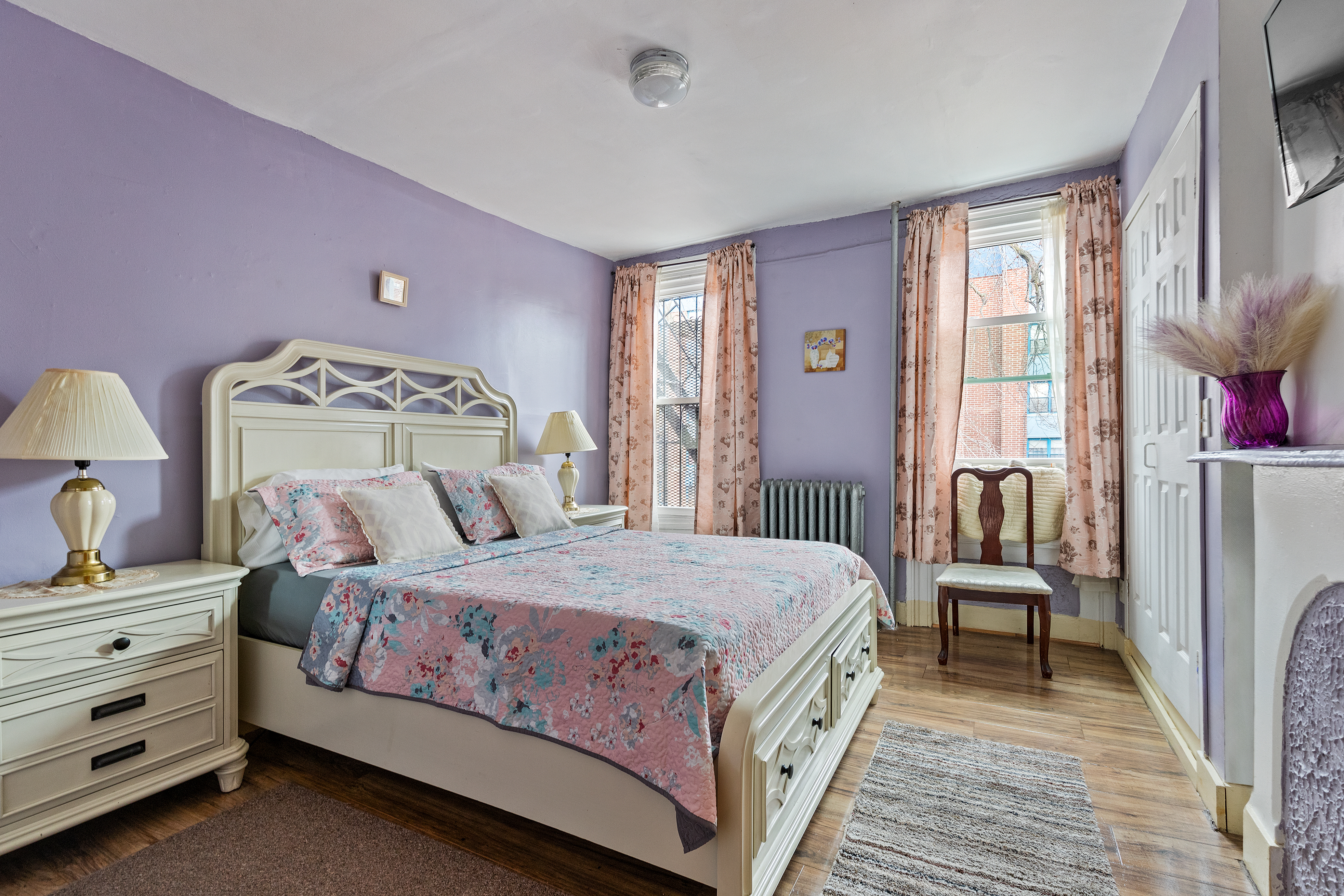 415 Monroe Street Brooklyn, NY 11221 - Photo 5 of 9 a bedroom with a bed and wooden floor