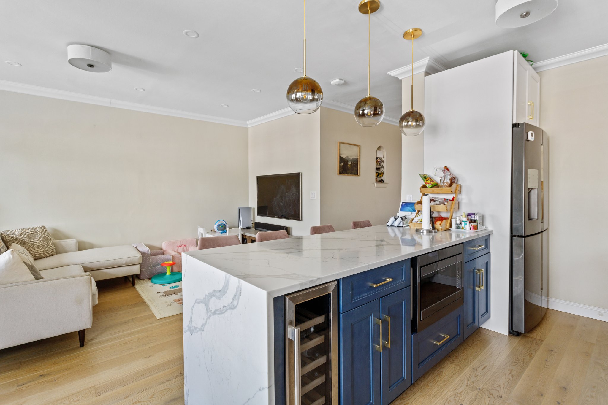 22-45 47th Street, Unit 3 Queens, NY 11105 - Photo 3 of 14 a view of kitchen sink stainless steel appliances and wooden floor