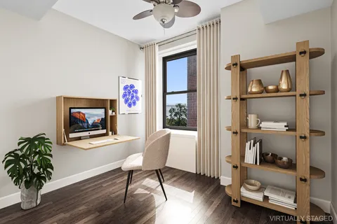 a workspace with wooden floor and a window