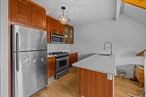 a kitchen with stainless steel appliances a refrigerator and a sink