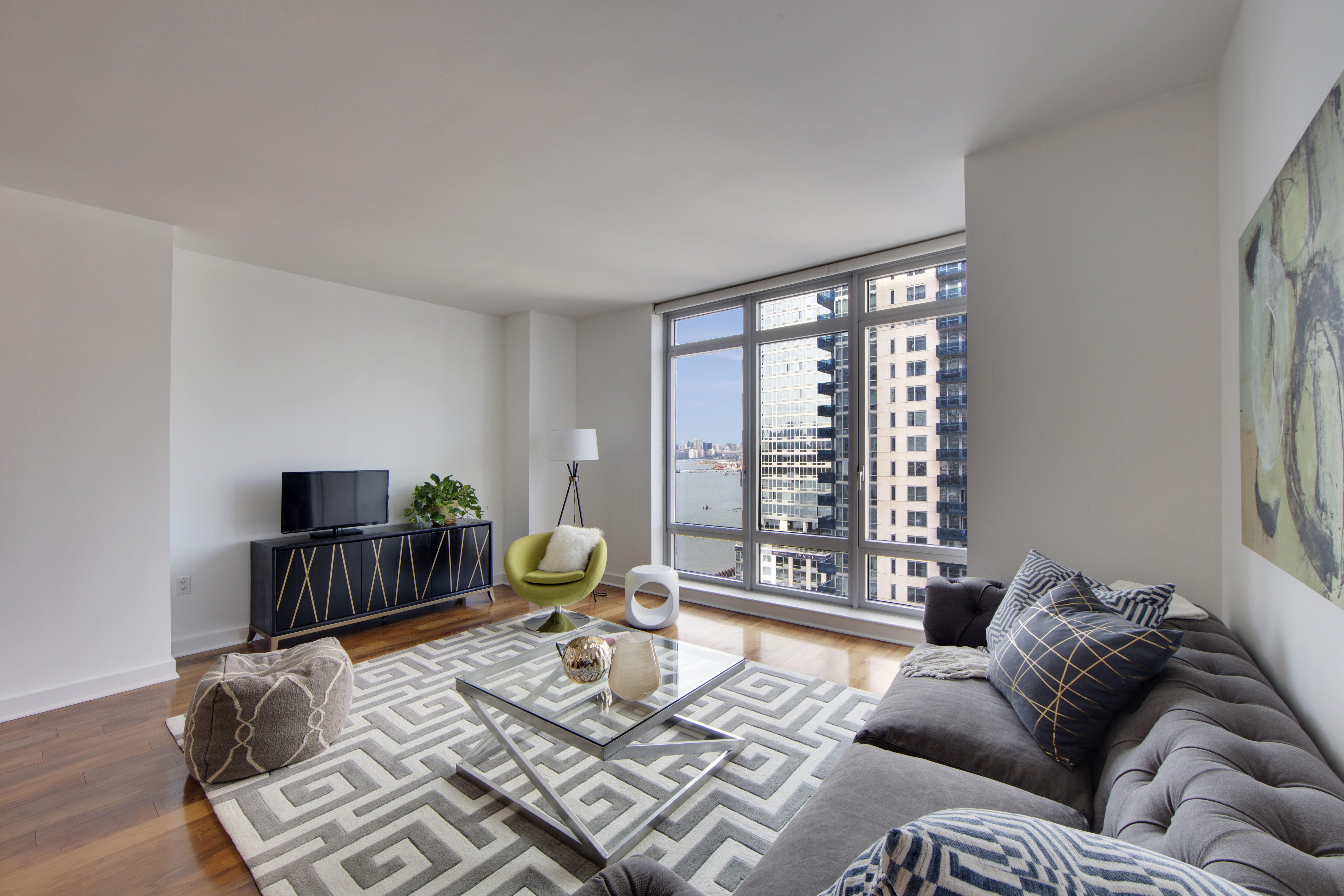 2 Northside Piers, Unit 8H Brooklyn, NY 11249 - Photo 4 of 20 a living room with furniture and a window
