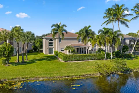 an aerial view of lake residential house with swimming pool and outdoor space