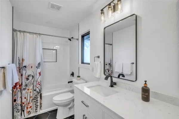 a bathroom with a sink toilet and shower