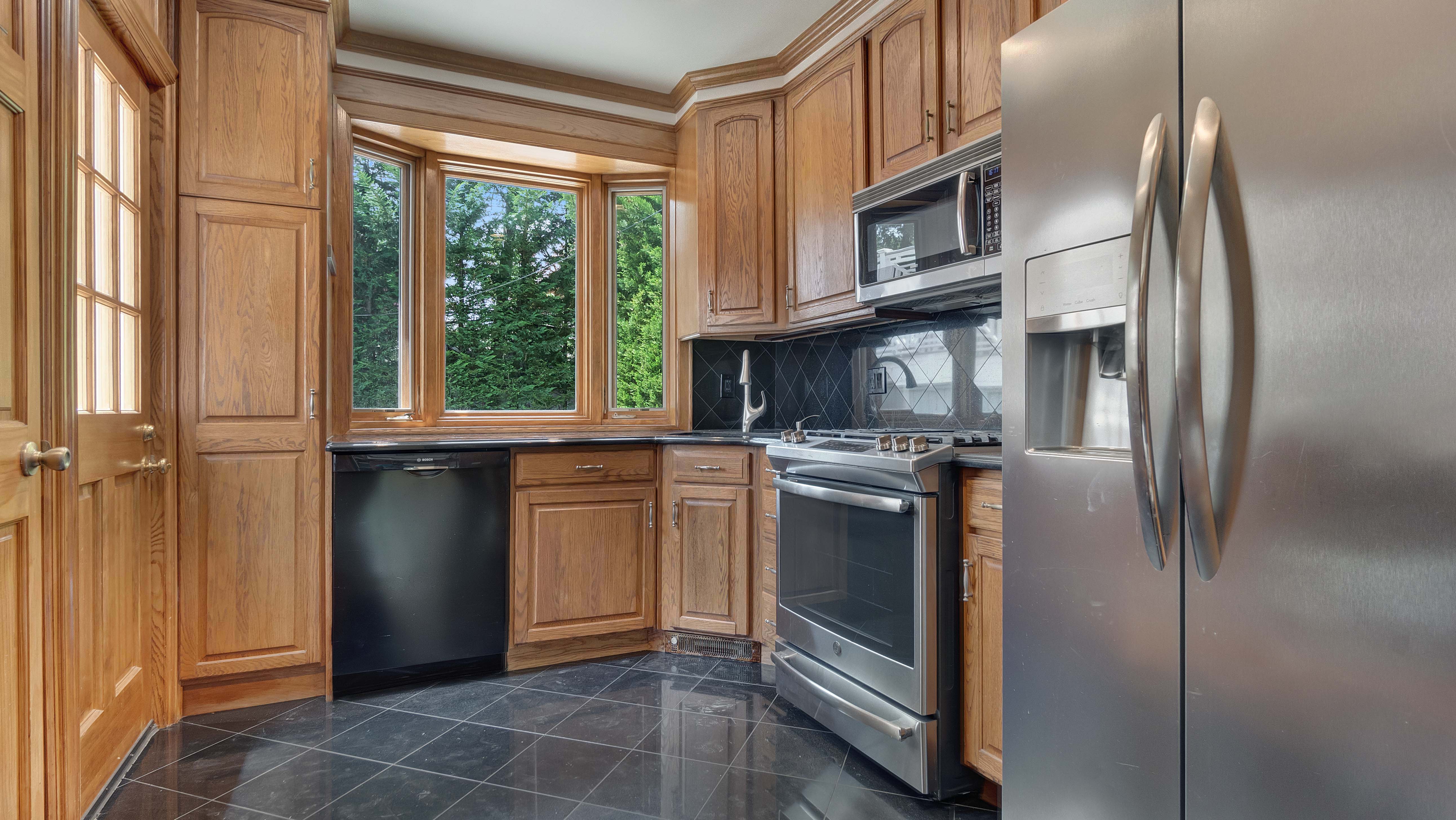 278 Amherst Street Brooklyn, NY 11235 - Photo 7 of 24 a kitchen with stainless steel appliances granite countertop a refrigerator and a sink