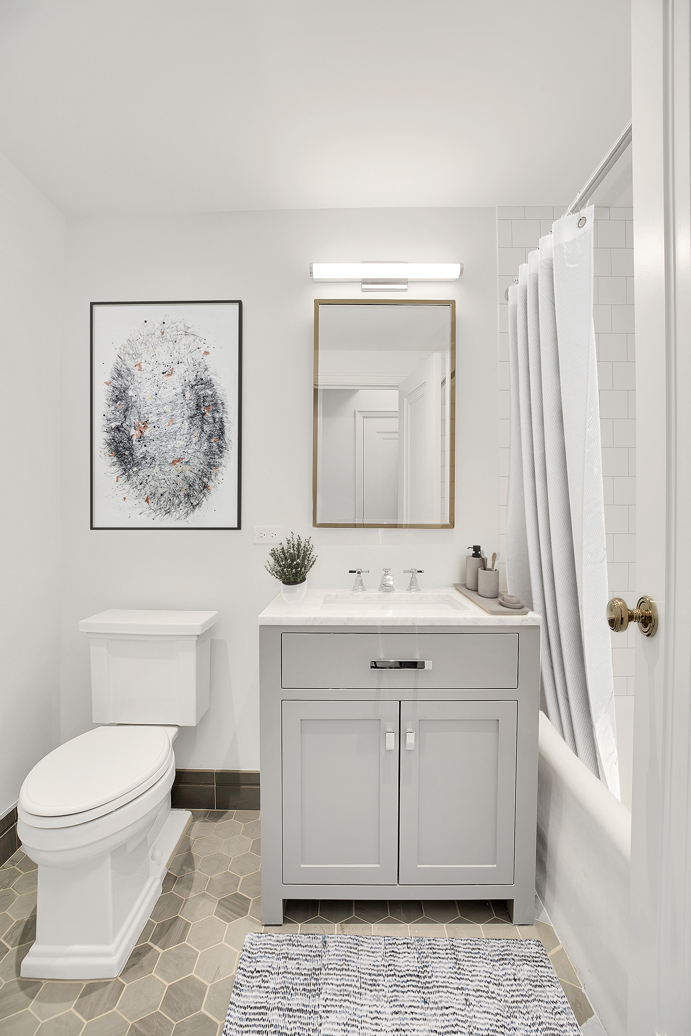 25 Central Park West, Unit 2Q Manhattan, NY 10023 - Photo 8 of 12 a bathroom with a toilet sink and mirror