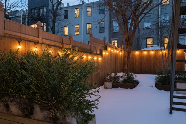a backyard of a house with lots of green space and outdoor seating