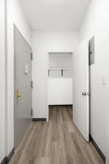 a view of a room with wooden floor