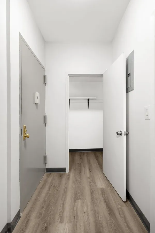a view of a room with wooden floor