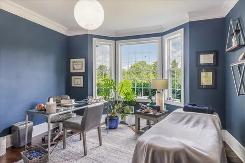a spacious bedroom with a bed and a tv on table