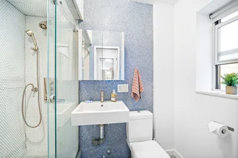 a bathroom with a toilet sink and shower